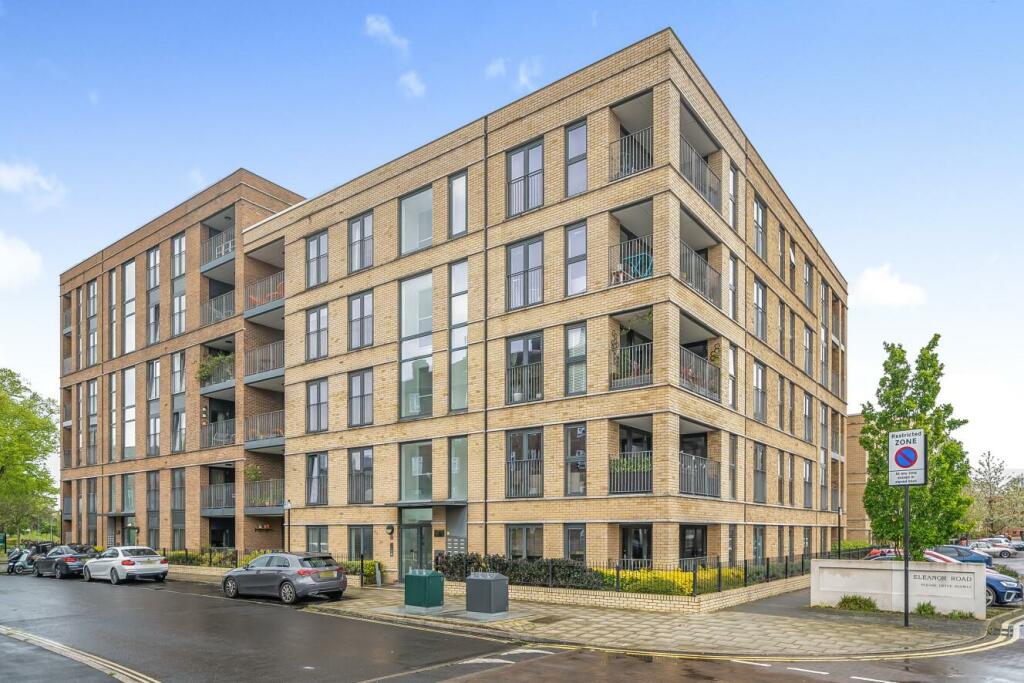 The brick apartment block at 57 and 59 Cowley Road, seen from the street corner